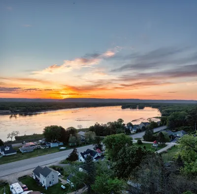 Stunning aerial sunset view over Reads Landing, MN, highlighting the tranquil waterscape and small-town charm.