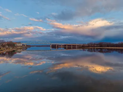 Beautiful sunrise reflections on the Mississippi River in Wabasha, Minnesota, showcasing a tranquil early morning scene.